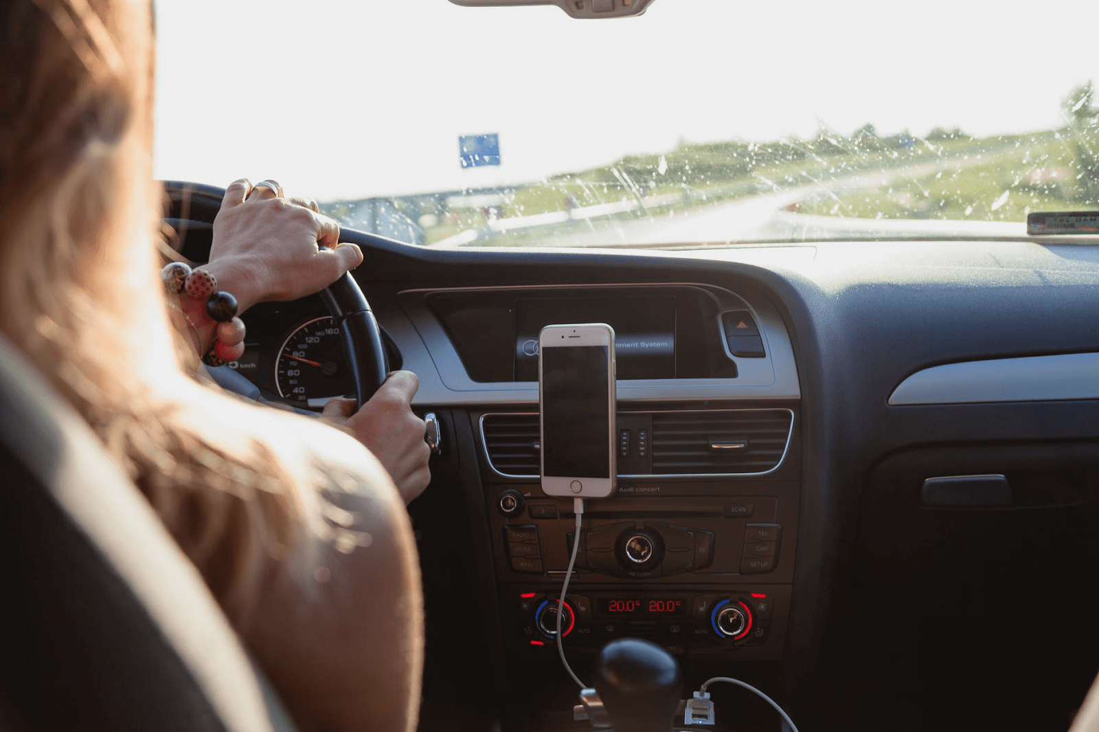 Carta de renuncia: mujer conduciendo con el teléfono montado en la rejilla de ventilación