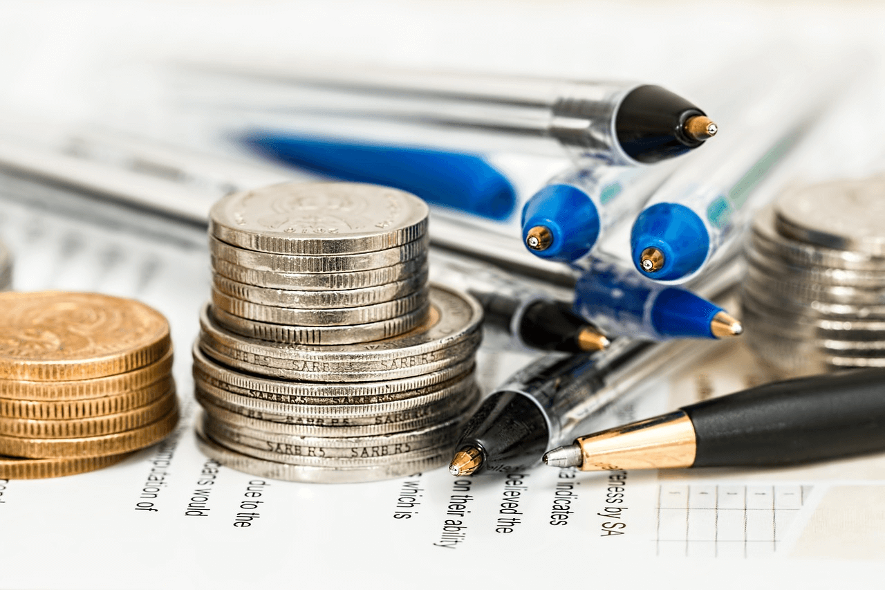 Amortización de préstamos: pilas de monedas y bolígrafos